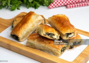 Traditional delicious Turkish food; Handmade Spinach Cheese Pie - pastry, Turkish name; el acmasi borek, rulo borek. Turkish borek rolls with spinach and cheese. A traditional Turkish pastry rulo borek