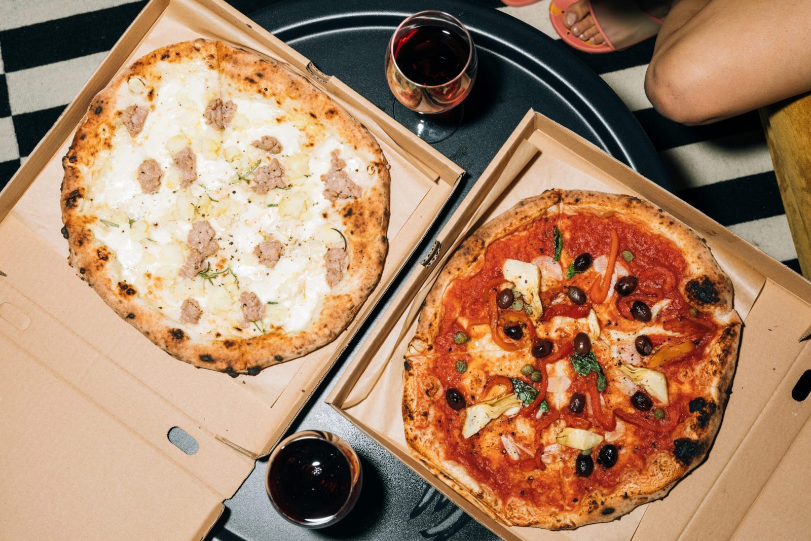 Top view of two pizzas on a table