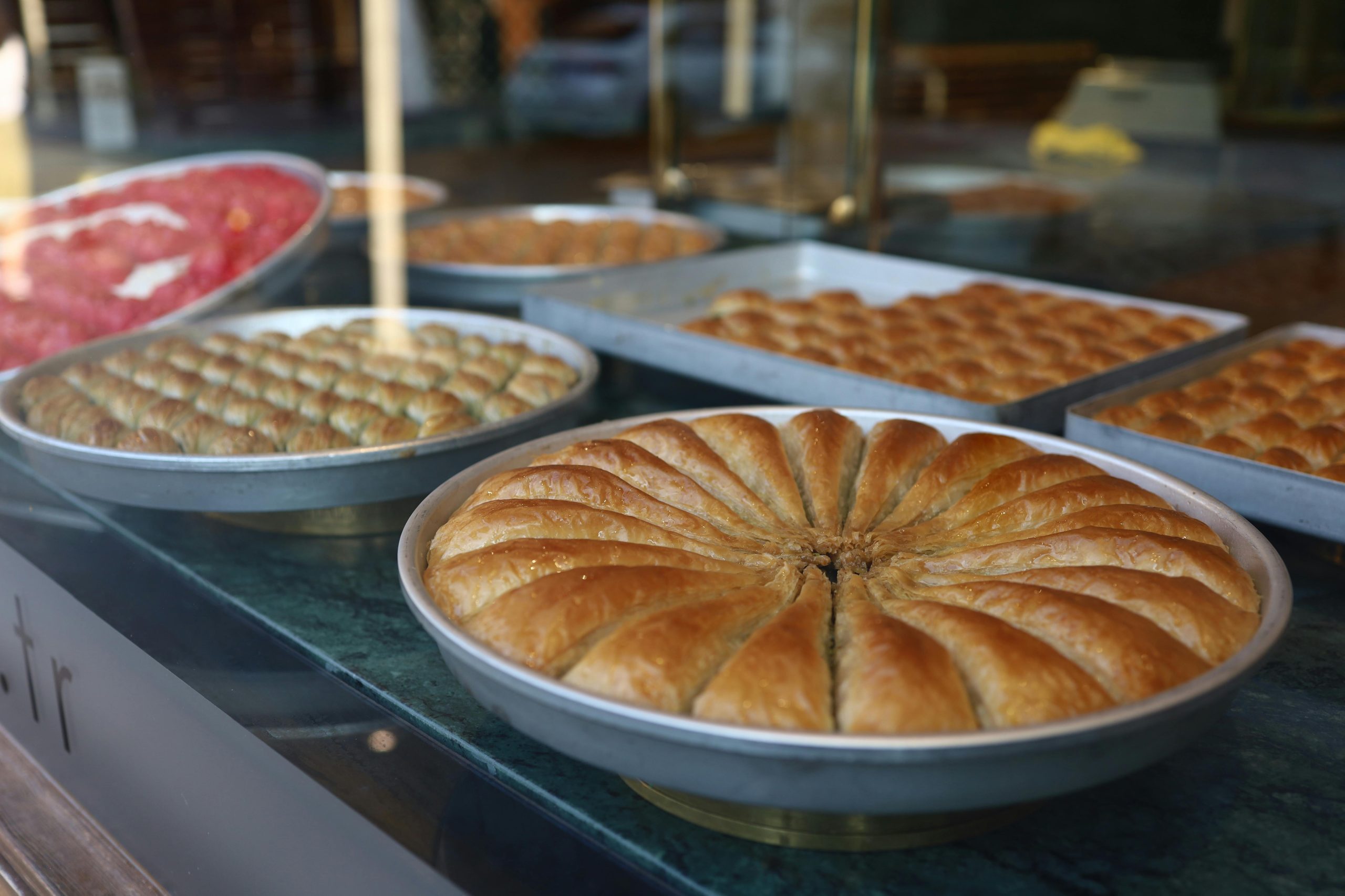 Delicious variety of traditional Turkish baklava on display in a Gaziantep pastry shop.