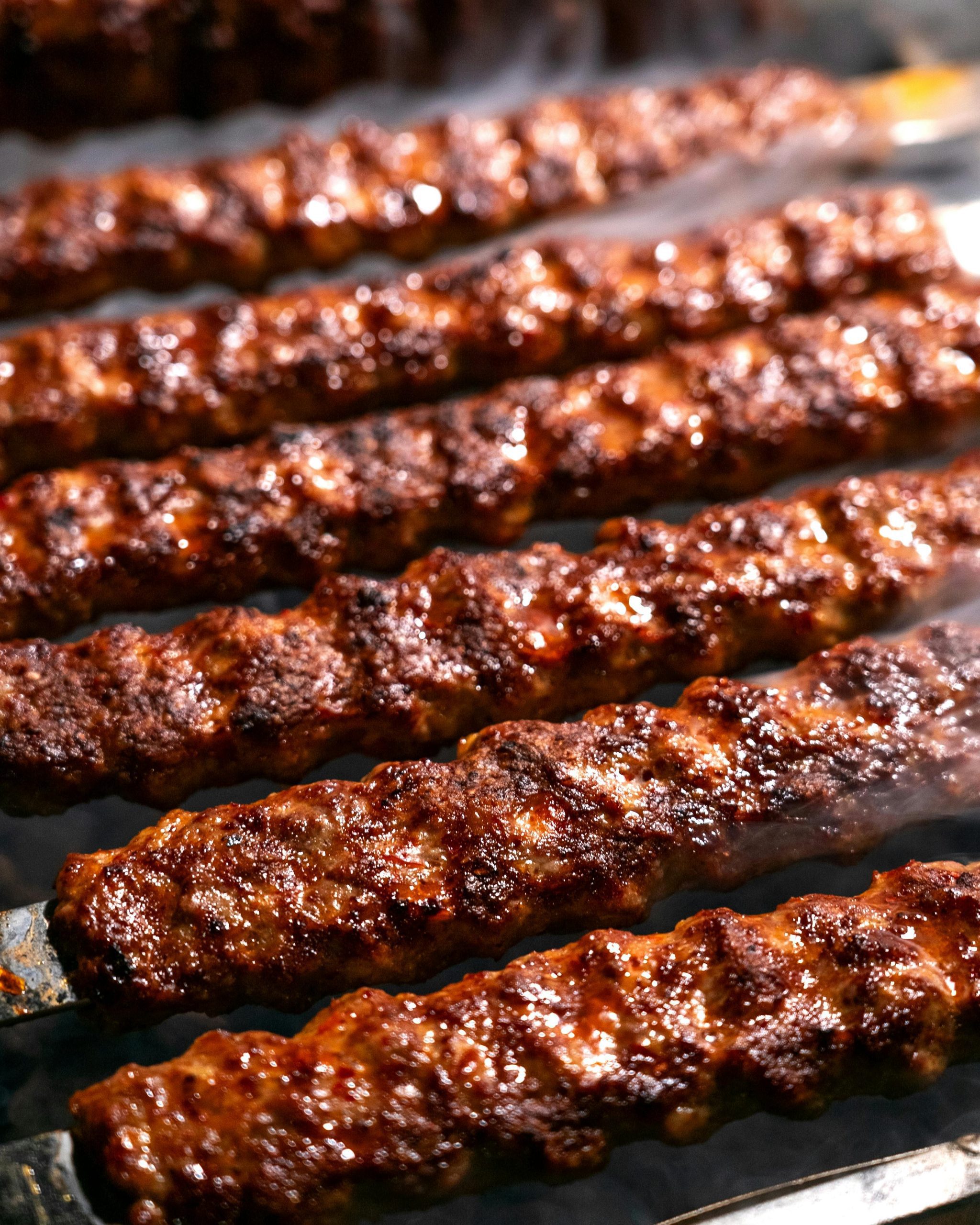 Grilled seekh kebabs on skewers close up