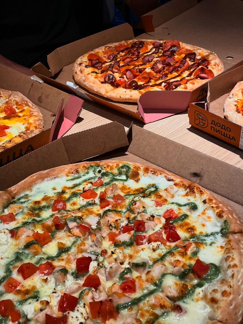 assorted flavorful pizzas in cardboard boxes