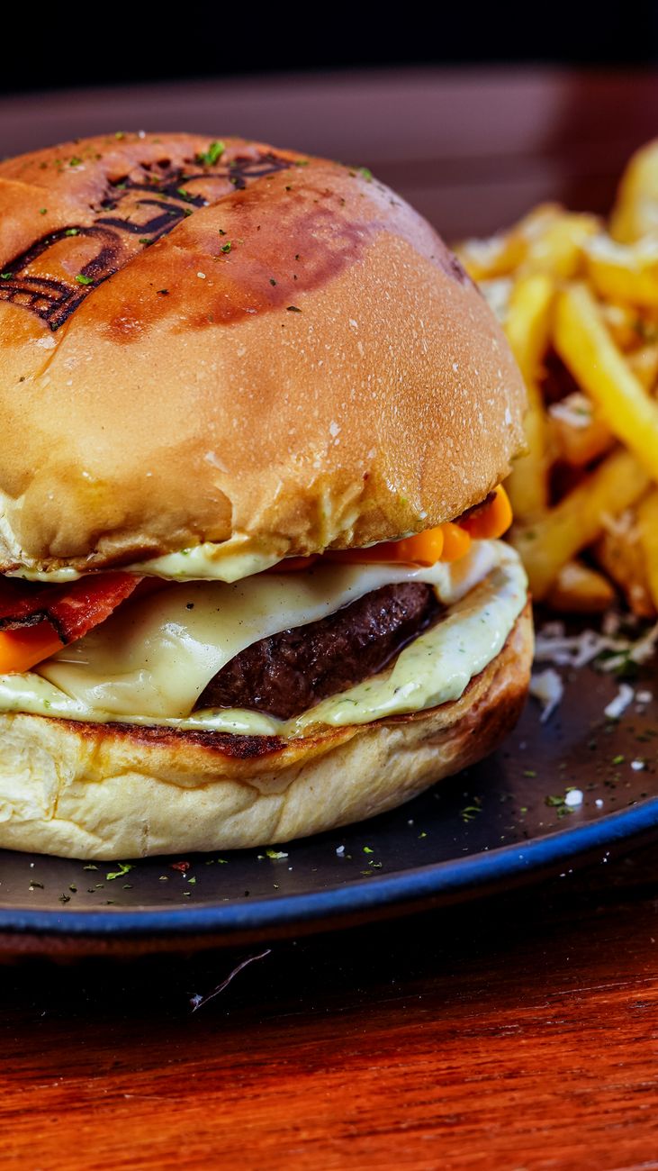 delicious cheeseburger with fries on plate