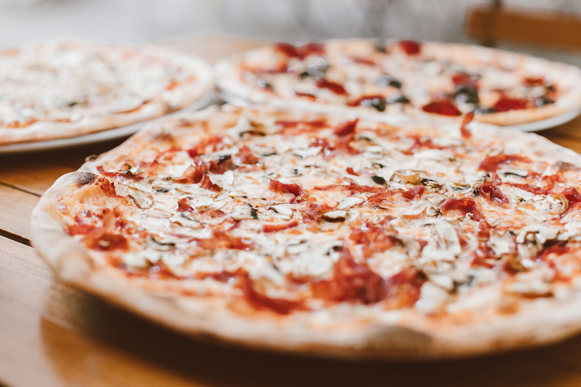 baked pizzas on a table